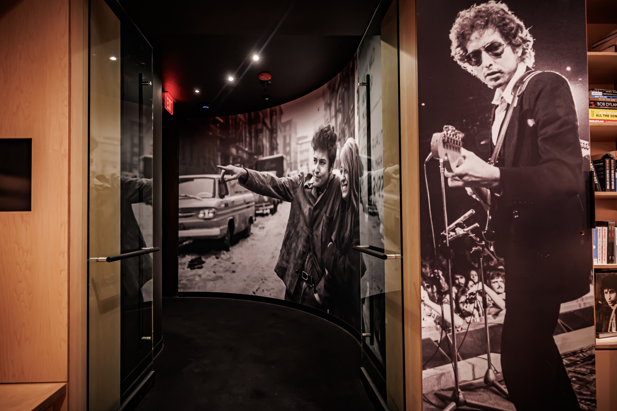 Entryway to Bob Dylan Center. Photo of hallway entering main gallery. Bob Dylan and Sure Rotolo on wall.